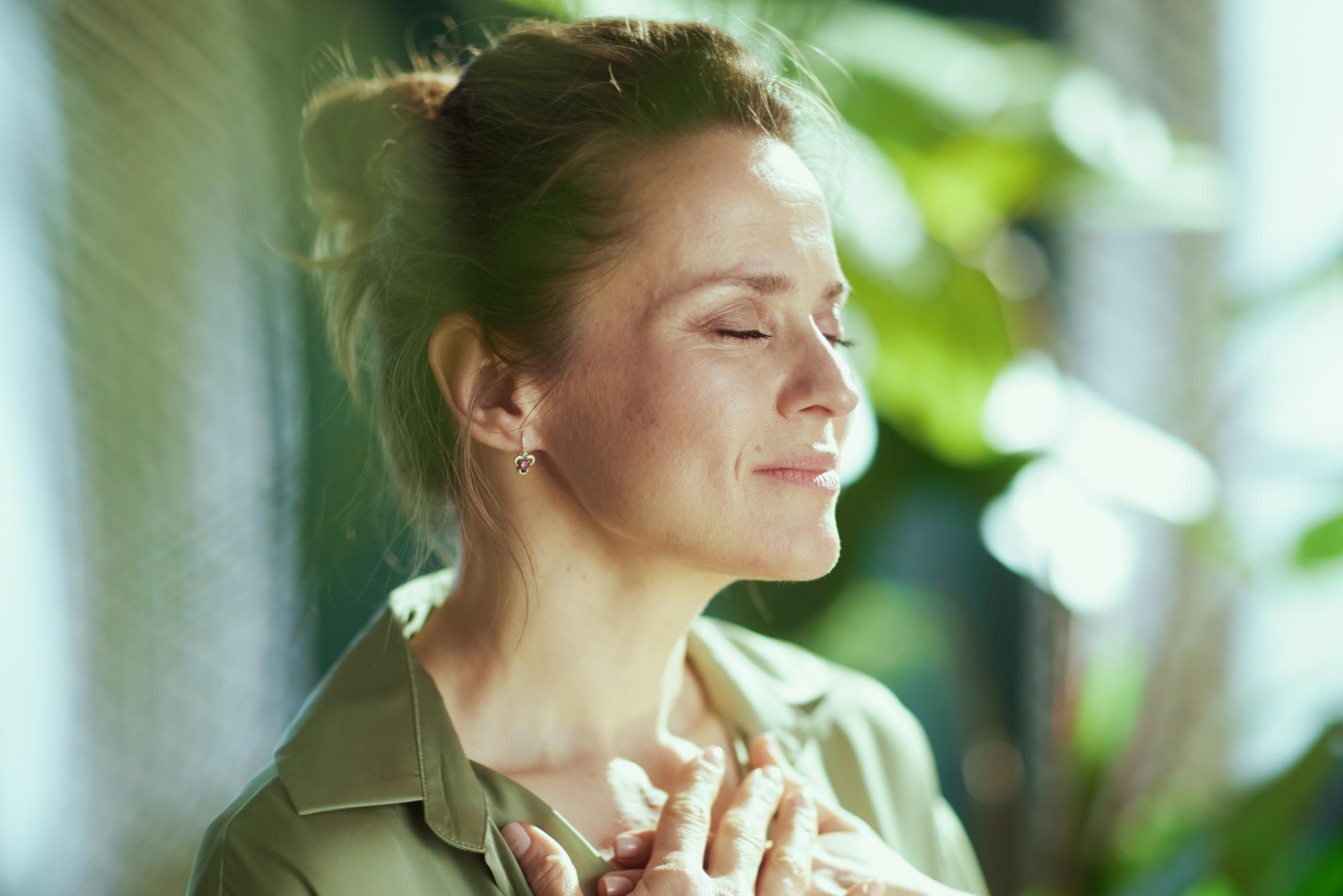 Female navigating educator burnout by implementing breathing patterns helpful for her nervous system.